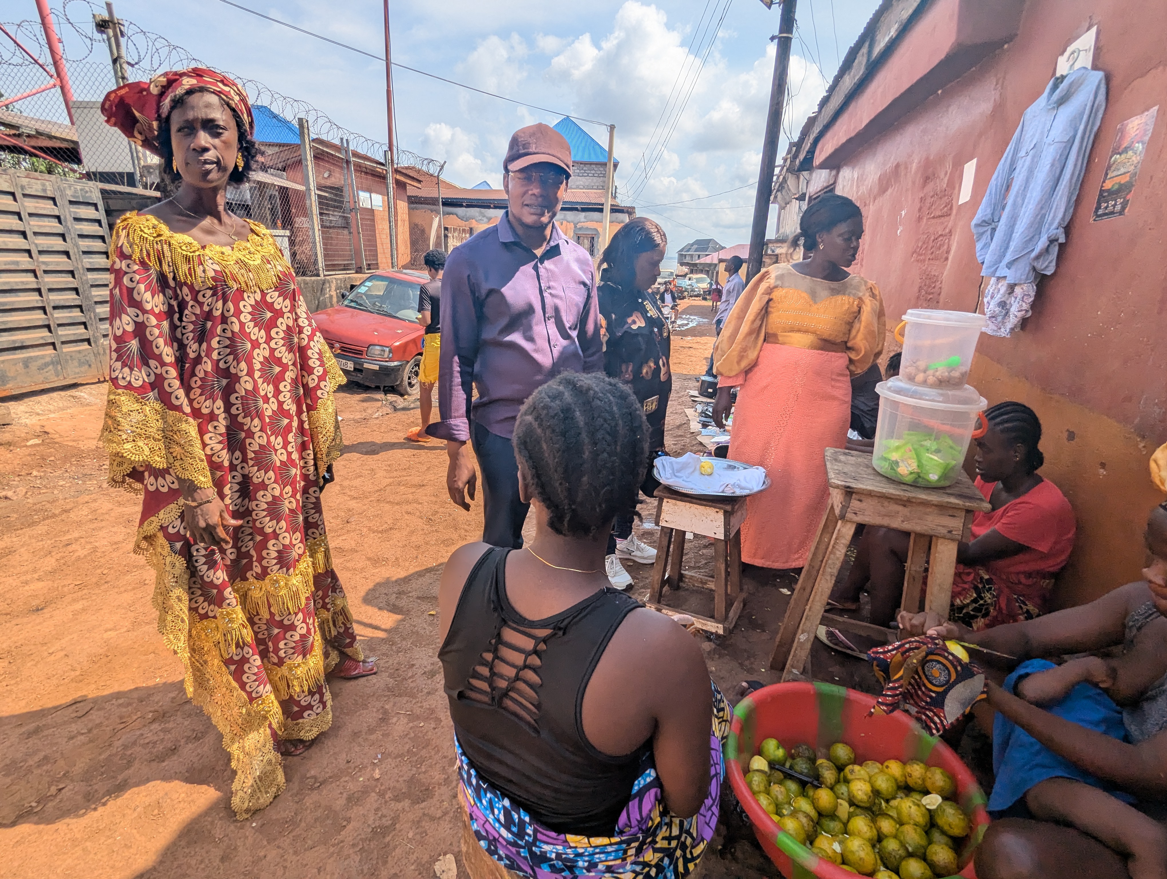 Agnes Marah (left), a local councillor whose district is home to more than 45,000 residents in Freetown’s Western Urban district, discusses local issues with constituents. Marah, known locally as the ‘Iron Lady’, is part of an International IDEA–backed initiative, along with a gender rights group that has trained hundreds of elected women on issues from campaigning on social media to writing grant applications. Credit: International IDEA/Alistair Scrutton